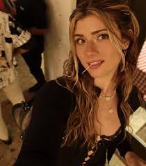 A sleek and modern thumbnail for a Faith Ordway biography blog. The image features a high-definition portrait of Faith Ordway in professional fitness attire, set against a split background: one half showing a sun-drenched Florida gym and the other half a dramatic, dimly lit boxing arena. Bold, stylized text overlays read "FAITH ORDWAY: THE 2025 GUIDE" and "BOXING, FAME, & THE SKETCH TRUTH