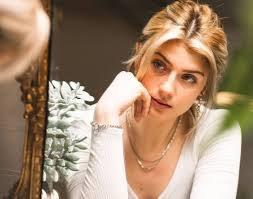 A sleek and modern thumbnail for a Faith Ordway biography blog. The image features a high-definition portrait of Faith Ordway in professional fitness attire, set against a split background: one half showing a sun-drenched Florida gym and the other half a dramatic, dimly lit boxing arena. Bold, stylized text overlays read "FAITH ORDWAY: THE 2025 GUIDE" and "BOXING, FAME, & THE SKETCH TRUTH