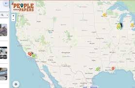 A conceptual thumbnail for the People Over Papers Map blog featuring multiple pairs of hands holding a paper map of the United States. The map is overlaid with red and yellow digital location pins marked with exclamation points to signify enforcement activity. The image features bold text at the top that reads